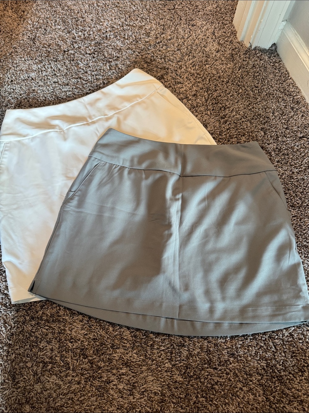 GOLF: two adidas golf skirts. Set in White and Light Gray